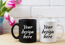 Black Coffee Mug and White Cappuccino Cup Mockup with Pink Tulips Poster 1