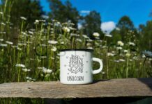 White Campfire Enamel Mug Mockup with Daisy Field. Poster 1